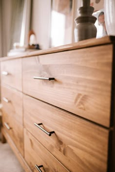 a close up of a dresser with drawers and knobs on the bottom part of it