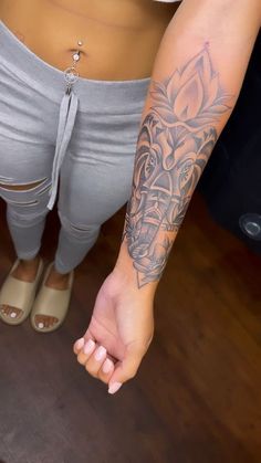 a woman with tattoos on her arm and leg