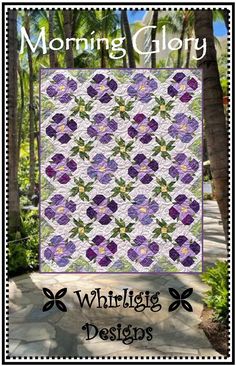 the cover of morning glory quilt, featuring purple flowers and green leaves on a white background