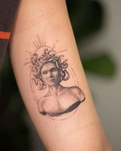 a woman's arm with a tattoo on it that has an image of a woman