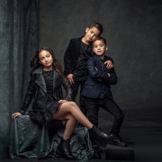 three children are posing for a portrait together