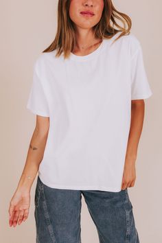 The Blinded Top: a basic white tee that's perfect for any occasion! Comfy enough for a casual day out, yet versatile enough to dress up or down. A must-have for any wardrobe. Details Crew neckline Basic tee Boxy fit Sizing Approximate measurements: SIZE LENGTH BUST Small 25" 44" Medium 26" 46.5" Large 26.5" 50" Fabric has some stretchModel is 5'8" wearing small Material 100% Cotton Hand wash coldDo not bleachHang dry Do not iron Effortless Summer T-shirt For Casual Gatherings, Summer T-shirt With Shirttail Hem, Effortless Spring T-shirt For Casual Gatherings, Basic Summer T-shirt For Everyday, Trendy Plain T-shirt For Everyday, White Casual T-shirt With Shirttail Hem, Casual White T-shirt With Shirttail Hem, Spring T-shirt With Shirttail Hem For Everyday Wear, Simple Relaxed Fit Top For Everyday