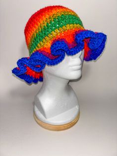 Add a splash of color to your outfit with our Burnt Rainbow Frill Bucket Hat! This unique accessory features a delightful blend of earthy rainbow hues, complemented by a charming frilly brim that adds a touch of whimsy to your look. Features: *Unique Design: Burnt rainbow colors for a vibrant and earthy aesthetic. *Charming Frill: A frilly brim that adds a playful and feminine touch. *Summer-Ready: Lightweight and breathable material ensures you stay cool and comfortable. *Sun Protection: Brim p Playful Multicolor Sun Hat For Spring, Playful Multicolor Wide Brim Sun Hat, Playful Adjustable Wide Brim Mini Hats, Adjustable Rainbow Hats For Summer, Adjustable Rainbow Summer Hats, Multicolor Yarn Hat For Summer, Multicolor Yarn Mini Hat One Size, Bohemian Multicolor Bucket Hat, Summer Wide Brim Hat With Ruffles