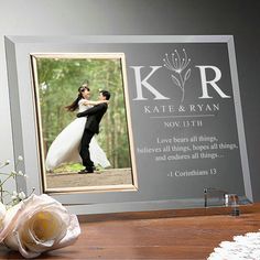 a wedding photo frame with a bride and groom holding each other in front of them