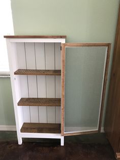 a book shelf with two shelves on each side and a sliding door in the middle