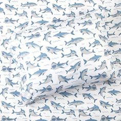 two sheets with sharks on them in blue and white