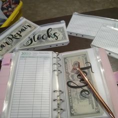 there is a binder with writing on it next to a pen and some money