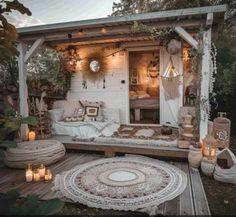 an outdoor living area with white furniture and candles