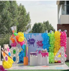 an outdoor birthday party with balloons and decorations