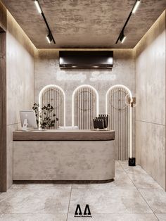 the interior of a store with white walls and stone flooring is lit by recessed lights