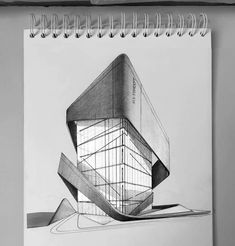 a drawing of a building on top of a table next to a pen and paper