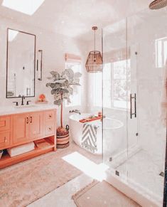 a bathroom with a tub, sink and large mirror on the wall next to it