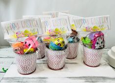 easter baskets filled with colorful eggs on top of a table