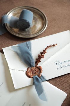 the wedding stationery is laid out on the table