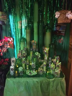 a table topped with lots of green bottles