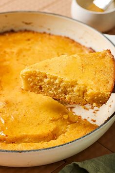 a piece of cornbread being lifted from a casserole dish with a spoon