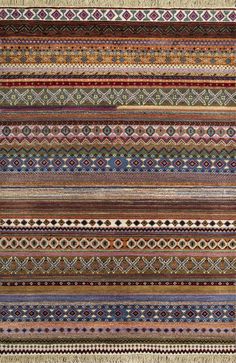 a multicolored rug with many different patterns