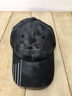 Camo cap with flag accent on visor. Structured, mid profile, tuck strap closure. These hats do NOT have mesh. If you want a mesh hat, please send me a convo. *(B)Pro Mid Crown *6 Panel *American Flag Woven Label on Visor and Back Arch *Cotton/Polyester Canvas Camo *One Size Fits Most *Pre-Curved Visor *Structured *Texas Flag Woven Label on Visor and Back Arch of Texas Versions *Tuck Strap with Slide Closure Blank hat $11.99 Custom Embroidered Hats With Your Logo For Only $14.99! NO MINIMUMS!! Th Adjustable Six-panel Hat With Custom Logo, Outdoor Baseball Cap With Embroidered Logo, Patriotic Black Baseball Cap For Outdoor, Black Patriotic Adjustable Baseball Cap, Patriotic Black Baseball Cap For Sports, Black Adjustable Patriotic Baseball Cap, Cap Business, Adjustable Black Patriotic Trucker Hat, Back Arch