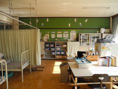 a room with bunk beds and desks in it