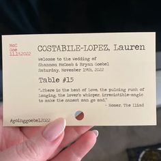 a person holding up a wedding card in their hand with the words, costable - looped, laurenn