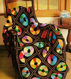 a crocheted blanket sitting on top of a chair