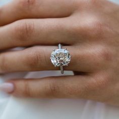 a woman's hand with a diamond ring on it