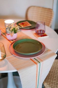 the table is set with plates, glasses and candles for dinner or party guests to enjoy