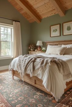 a large bed sitting in a bedroom next to a window on top of a rug