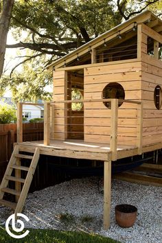 a small wooden play house with stairs leading up to it