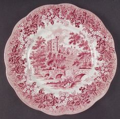 a red and white plate with a castle on it