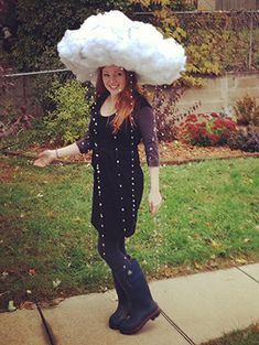 a woman wearing a large cloud hat on her head