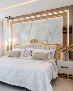 a bedroom with marble walls and white bedding