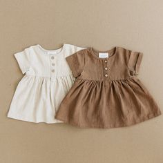 This is a linen cotton short sleeve dress with wood buttons! Sizes 0-3 up to 4T. Such a cute, simple, dress for your baby.  Wash in cold water, Hang dry.   40% Linen  60% Cotton    measurement in inches Length Width 0-3 month 11.5 10 3-6 month 13 10.5 6-12 month 14.5 11 18 month 16.5 11 2T 18 11.5 3T 20 12.5 4T 22.5 13 Cute Simple Dress, Baby Camel, Cotton Linen Dresses, Wood Buttons, Fashionable Baby Clothes, Simple Dress, Baby Outfits, Short Sleeve Dress