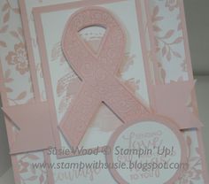 a close up of a card with a pink ribbon on the front and back of it