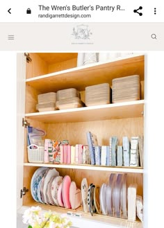 a wooden shelf filled with lots of plates and bowls