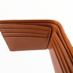 Improved classic design Embossed full grain vegetable tanned premium leather RFID - protected 3.3"H x 4.1"W x 0.5"D (folded) Holds 6 – 12 cards 2 slip pockets Flat bill section Fabric lining Branded gift box Imported Brown Bifold Wallets For Personal Use, Customizable Brown Bifold Wallet, Formal Textured Leather Bifold Wallet, Brown Textured Leather Bifold Wallet, Brown Leather Trifold Wallet Hand-stitched, Alligator Skin, Brown Wallet, Wallet For Men, Brown Leather Wallet