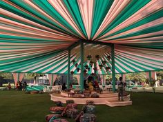 the inside of a large tent with green and white stripes