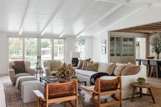 a living room filled with furniture and lots of windows