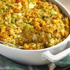 a casserole dish filled with stuffing and vegetables