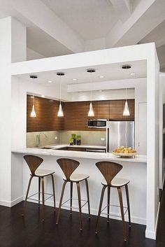 three bar stools sit in front of an island