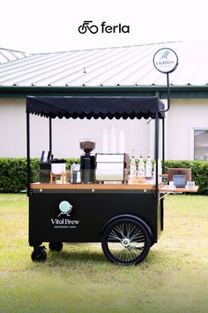 an outdoor food cart is parked in the grass