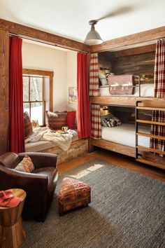 a living room with bunk beds and couches next to a window in the corner