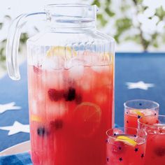 watermelon juice in a pitcher and two glasses on a blue plate with white stars