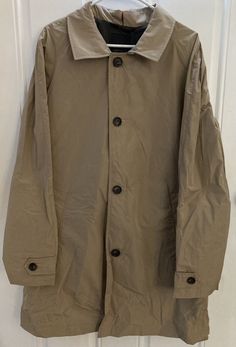 TUMI Summit Mackintosh packable trench rain coat, size L. Includes packable zippered pouch. Measures about 26” flat across the chest from pit to pit and 36.5” long from collar seam down back to waist. Please zoom in on all pictures for detail. Ships fast and free from a clean smoke free home. There are 3 coats available for sale, but two of them do not have the product/pricing/UPC tag. All 3 coats are new and unworn and they all have the “Packable” tag attached to the zippered pouch. However, if Classic Long Sleeve Raincoat For Outdoor, Classic Windbreaker For Outdoor, Classic Outdoor Windbreaker, Packable Outerwear For Fall Travel, Long Sleeve Khaki Raincoat, Beige Long Sleeve Raincoat, Beige Long Sleeve Raincoat For Rainy Weather, Weatherproof Long Sleeve Outerwear For Travel, Classic Outerwear For Rainy Season