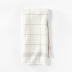 a white and grey checkered napkin on a white background