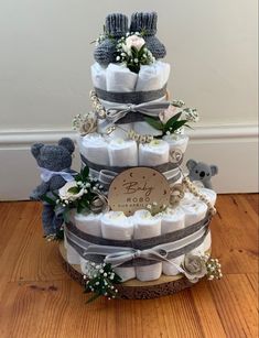 a three tiered diaper cake with teddy bears on it