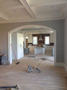 a room with hard wood flooring and tools on the ground in front of it