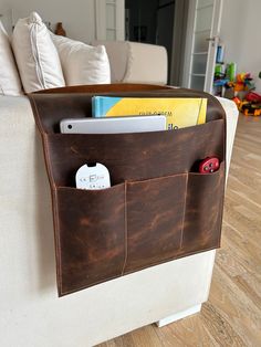 a couch with a leather storage pocket on it