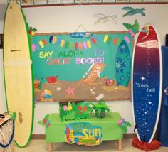 there are surfboards that are on display in the room with signs and decorations around them