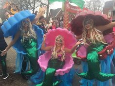 three women dressed in mermaid costumes posing for the camera